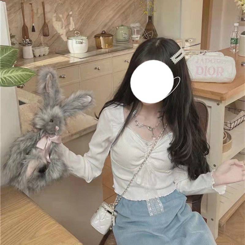 053d393c-45b7-476c-ac87-e61ef36881cb.jpg A Woman Wearing A Sweater With A Base Top - Image 2