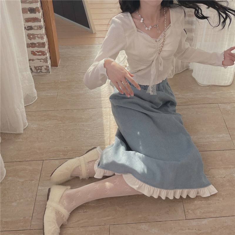 ea2dee6a-1667-4218-8c76-90409faf4302.jpg A Woman Wearing A Sweater With A Base Top - Image 1